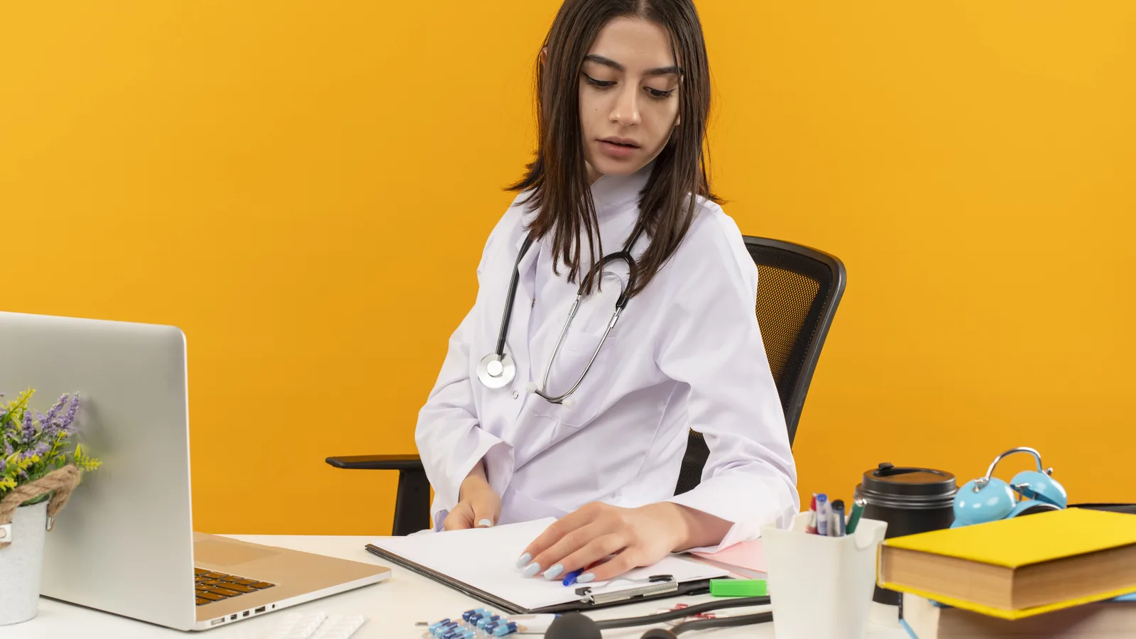 Clinician working late on documentation after a full caseload