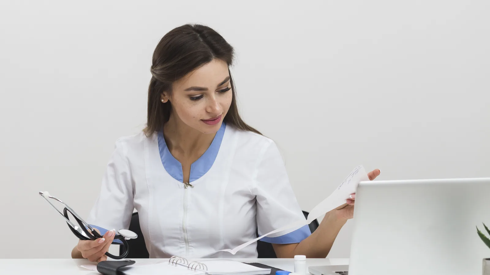 Clinician reviewing documentation and insurance paperwork